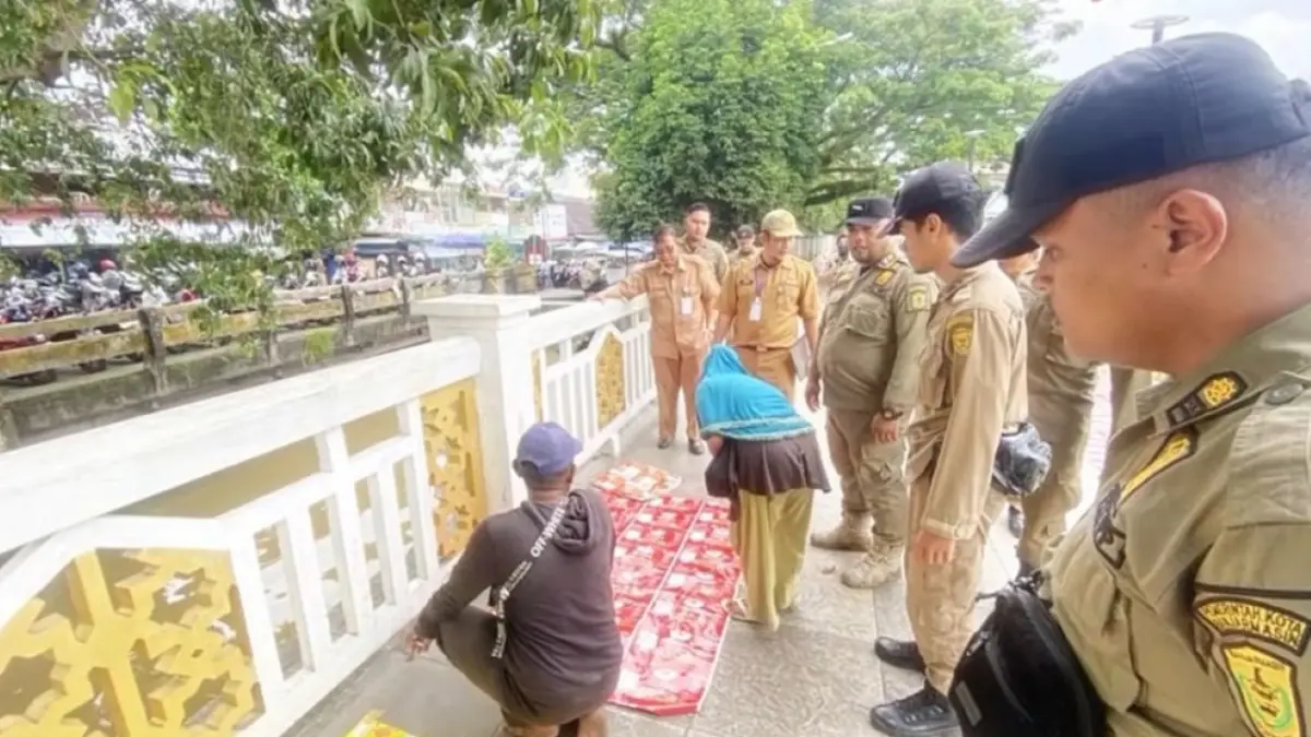 Petugas Satpol PP Banjarmasin melakukan penertiban terhadap oknum yang sempat mengkavling tempat duduk kawasan Siring Nol Kilometer Banjarmasin dengan alas dan dikenakan biaya. (Screenshot postingan @hj.ananda)