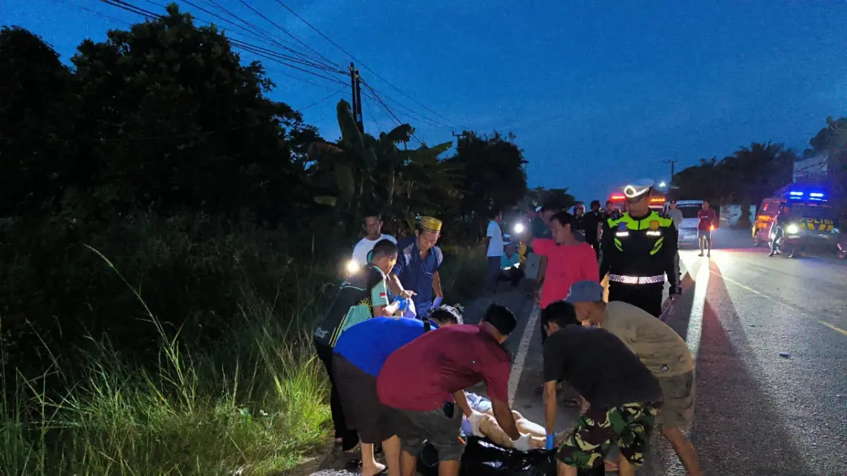 EVAKUASI : Personel Satlantas Polres Tala bersama Polsek Jorong dan relawan melakukan evakuasi korban kecelakaan di Jalan A Yani, Desa Asam-Asam, Kecamatan Jorong, Minggu (12/4/2026). (Foto : Polsek Jorong untuk Radar Banjarmasin)