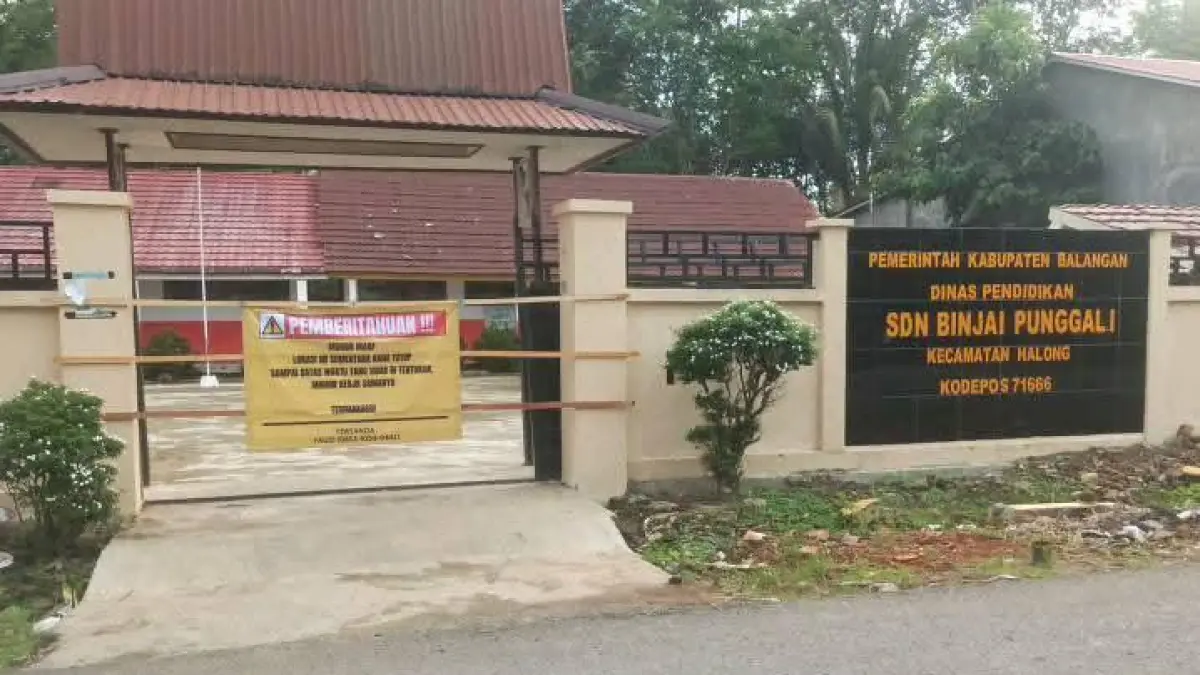 SEGEL SEKOLAH: Gerbang SDN Binjai Punggal di Kecamatan Halong yang dipasang spanduk penutupan sementara akibat masalah lahan pada Rabu (29/4/2026).