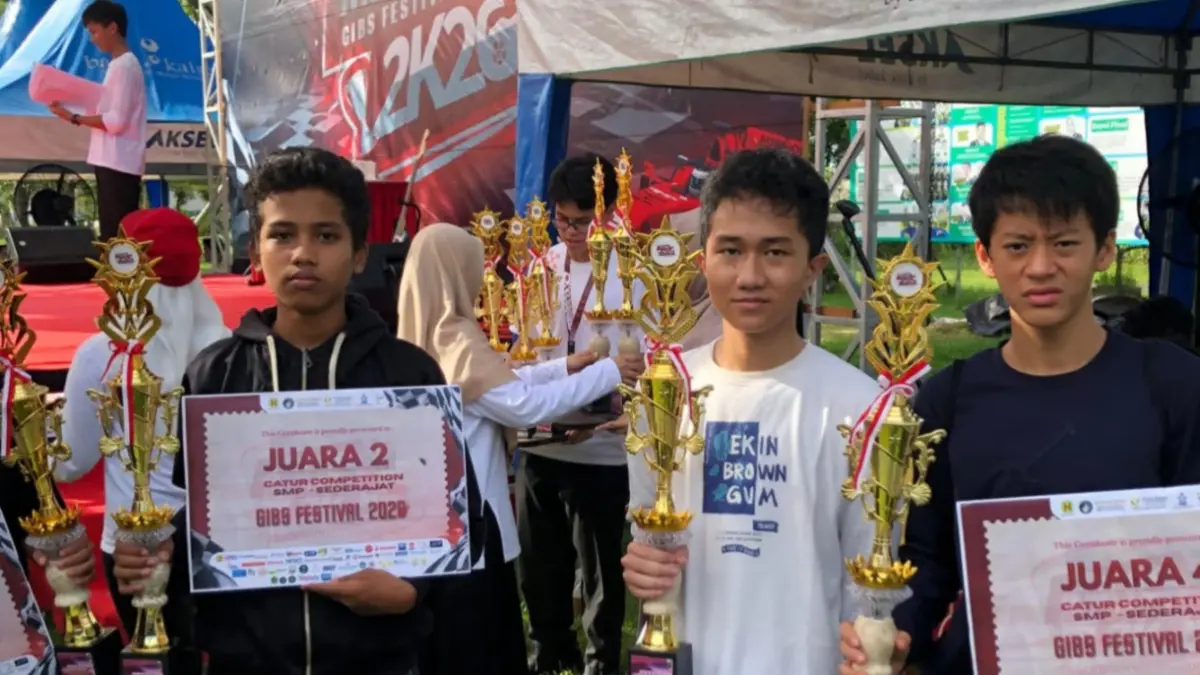 JUARA CATUR: Aditya Putra Pratama, Miseal Erico Wenas, dan Ibnu Hanif, tiga murid pecatur Master Fide (MF) Miftahul Hudany asal Banjarmasin, berpose dengan piala yang mereka raih dalam kejuaraan catur cepat GIBS Festival 2026 kategori SMP sederajat di Global Islamic Boarding School (GIBS). 