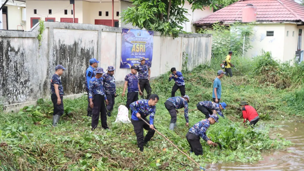 AKSI NYATA: Personel Satpolairud bersama anggota Polres Barito Kuala melakukan pembersihan sungai dan bantaran di kawasan Jalan Gusti M Seman, Marabahan, Jumat (12/6), dalam rangka menyambut Hari Bhayangkara ke-80. //HUMAS POLRES BATALA UNTUK RADAR BANJARMASIN