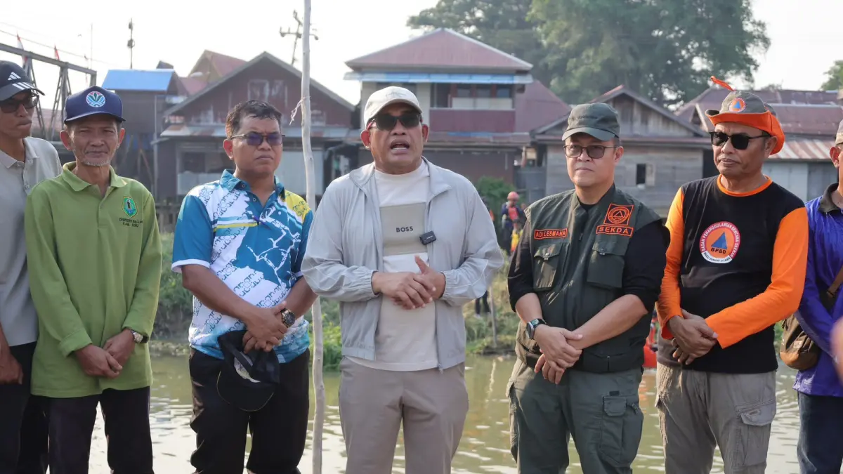 PARTISIPASI: Bupati HSU, H Sahrujani bersama jajaran Pemerintah Daerah dan ASN bergotong royong membersihkan sedimentasi di kawasan Jembatan Pasar Babirik.