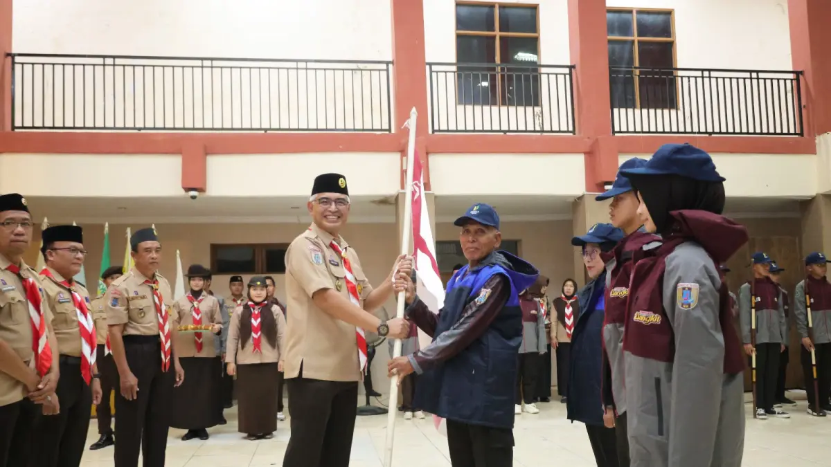 MOMEN: Ketua Kwarcab Gerakan Pramuka HSU, Hero Setiawan menyerahkan Pataka kepada Pimpinan Kontingen Cabang (Pinkoncab) saat pelepasan Kontingen HSU menuju Jambore Nasional XII di Gedung Pancasila Amuntai. (Foto: Pemkab HSU)