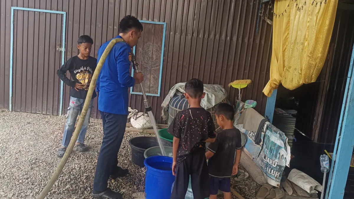 RESPONSIF: Petugas mendistribusikan bantuan air bersih menggunakan mobil tangki kepada warga Desa Sungai Limas, Kecamatan Haur Gading, HSU, yang terdampak kekeringan akibat musim kemarau. (Foto: Damkar HSU)