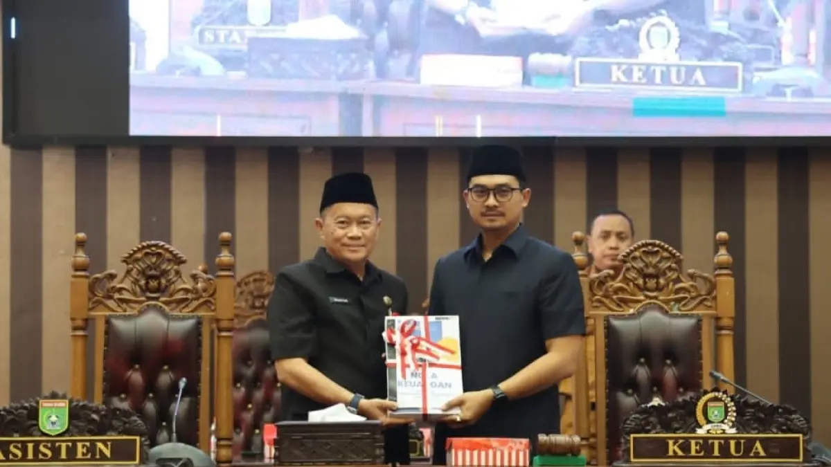 PENYERAHAN: Asisten Ekobang Eryanto Rais menyerahkan Rancangan Perubahan APBD 2026 kepada Ketua DPRD Tanah Bumbu dalam rapat paripurna.