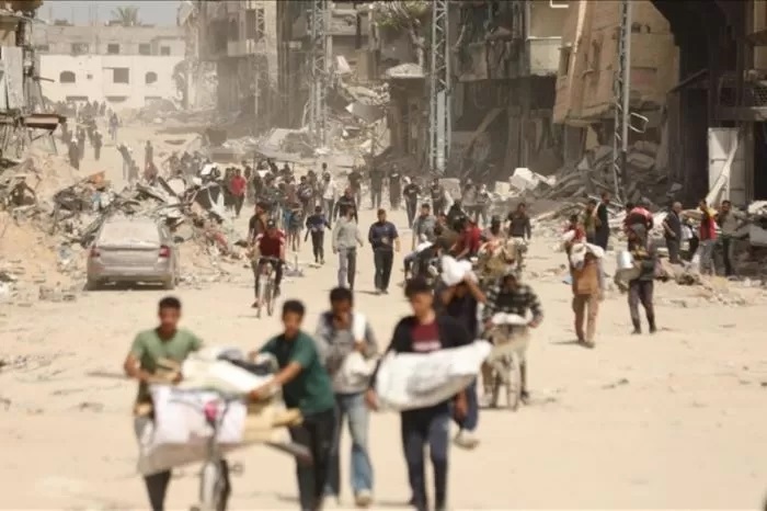 Warga Palestina di Jalur Gaza berjalan di tengah reruntuhan bangunan yang hancur akibat serangan Israel. (Anadolu/Antara)