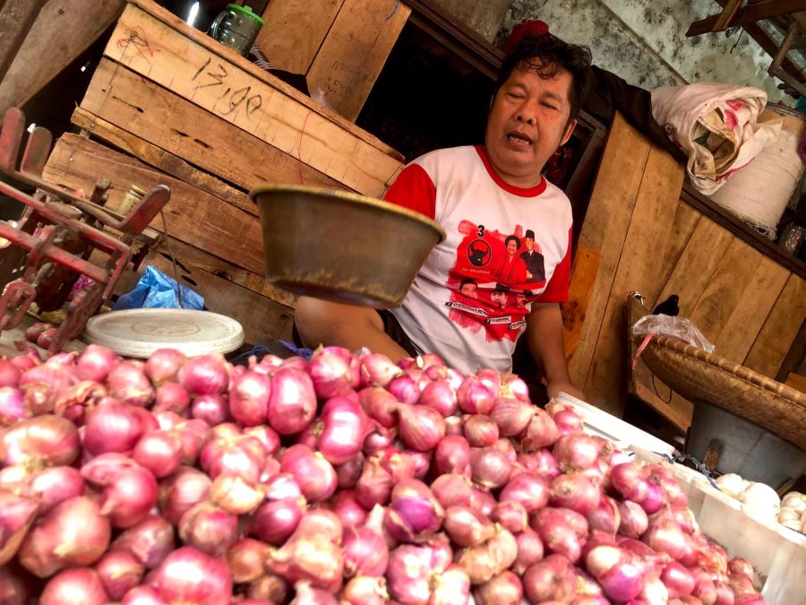 LEBIH MURAH: Pedagang menimbang bawang merah. Di pasar tradisional Banjarmasin, bawang merah dan bawang putih dijual dengan harga Rp45.000 per kilogram.&nbsp; (FOTO: TIA LALITA NOVITRI/