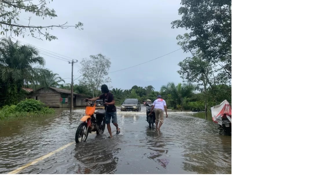 BANJIR: Pengendara motor melewati genangan banjir di Desa Pacakan, Kecamatan Kusan Hulu, Kabupaten Tanah Bumbu, Selasa (4/6/2024). (Foto: Zulqarnain/Radar Banjarmasin)