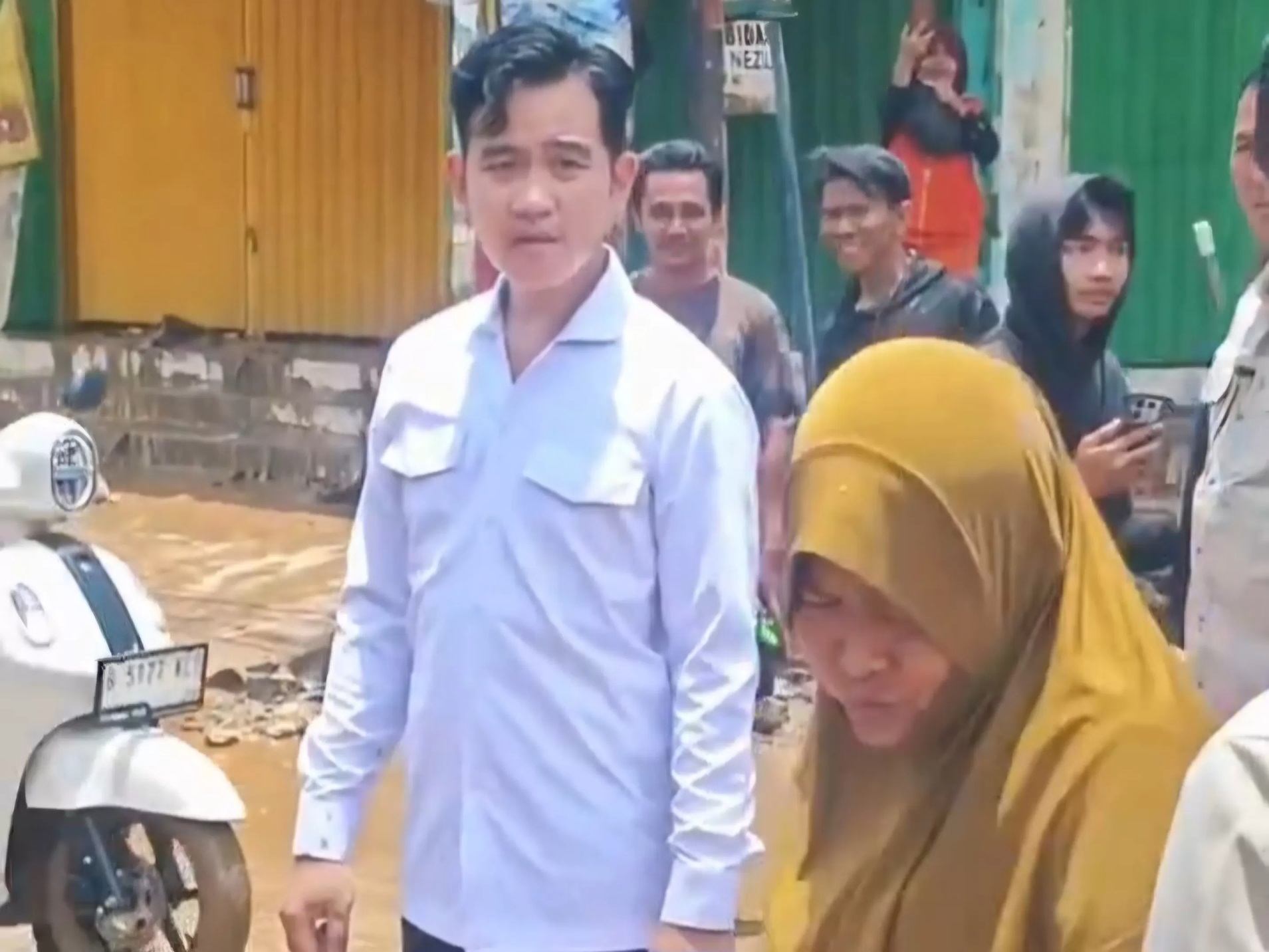 Tangkapan layar momen Gibran menawarkan bantuan kepada warga terdampak banjir di Bekasi, respons emak-emak ini jadi sorotan. (X/@BungkusTukang)