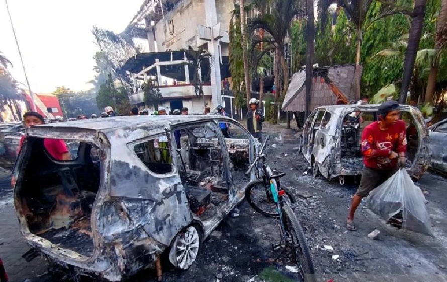 Sejumlah orang menggondol barang hasil jarahan usai Kantor DPRD Makassar dibakar massa, di Jalan Andi Pangeran Pettarani, Makassar, Sulawesi Selatan, Sabtu (30/8/2025).  (ANTARA/Darwin Fatir/pri)