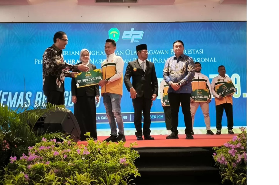 Plt Kadispora Kaltim M Faisal saat menyerahkan simbolis bonus kepada pelatih cabor peraih medali PON. Terkait porprov, Faisal mengatakan sejauh ini belum ada perubahan atau penundaan.