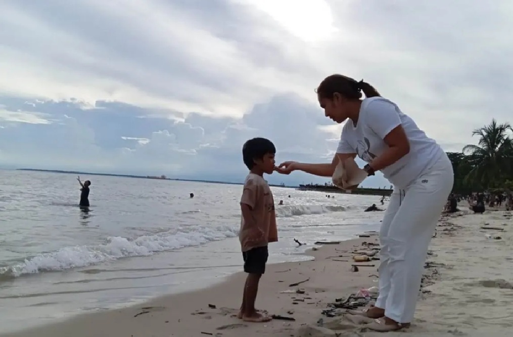 Ilustrasi - Seorang ibu sedang menyuapi anak saat bermain di Pantai Kilang Balikpapan. (ANTARA/ M Ghofar)