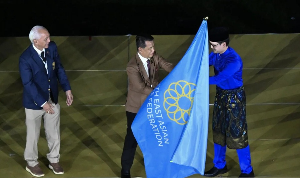 Tan Sri Dato' Sri Mohamad Norza Zakaria (tengah) menyerahkan bendera Federasi SEA Games (SEAGF) kepada Minister of Youth and Sport Malaysia Mohamad Taufiq bin Johari (kanan).