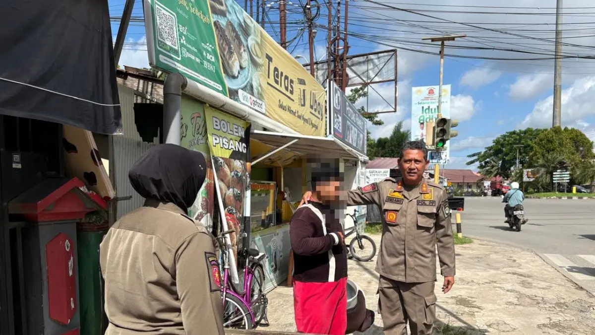 Personil Satpol PP Kukar menegur badut kostum di simpang lampu merah Unikarta (Istimewa)