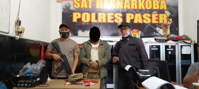 DIJAGA KETAT: Tersangka JWB (tengah) beserta barang bukti diamankan di Polres Paser. IST.