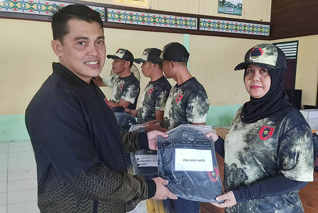 BENTUK PERHATIAN: Usai melaksanakan jalan santai dan senam bersama, Dandim 0902/BRU, Letkol Inf Dony Fatra, berikan jaket olahraga kepada Prajurit dan PNS Kodim 0902/Berau.