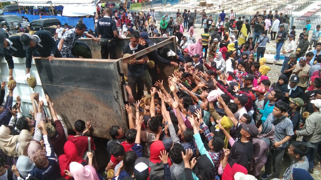 Para warga saat berebut durian gratis dalam acara Gerakan Makan Buah Lokal Bersama Paman Birin di Kiram Park. | FOTO: SUTRISNO/RADAR BANJARMASIN