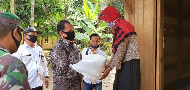 PENGAWASAN : Ketua DPRD Balangan Ahsani Fauzan (kiri) saat turut serta menyalurkan Bansos kepada masyarakat. | FOTO: WAHYUDI/RADAR BANJARMASIN.