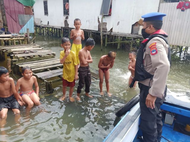 IMBAUAN: Bocah yang bermain di sungai, disambangi personel Polair. Mereka diminta berhati-hati, mengingat sedang musim air pasang tinggi. | FOTO; SATPOLAIR POLRESTA BANJARMASIN FOR RADAR BANJARMASIN