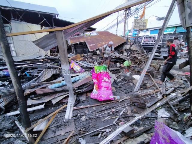 DI TENGAH PUING: Pemilik bengkel mengais-ngais di tengah sisa kebakaran. Mencari barang yang masih bisa dimanfaatkan. Penyebab kebakaran masih diselidiki polisi. | Foto: MAULANA/RADAR BANJARMASIN