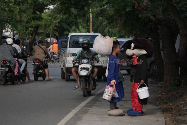 MASIH KECIL: Dua anak kecil mengenakan kostum badut di kawasan Teluk Tiram Darat. Foto diambil akhir tahun kemarin. | FOTO: WAHYU RAMADHAN/RADAR BANJARMASIN