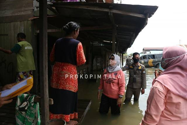 BERENDAM: Ketua TP PKK Tala Hj Nurul Sukamta menyambangi warga sembari mendistribusikan bantuan di tiga kecamatan.