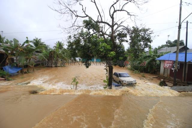TERJEBAK: Kendaraan milik warga terjebak banjir saat air menggenangi wilayah Kelurahan Bangkal, Kecamatan Cempaka pertengahan Januari lalu. | Foto: Rifani/Radar Banjarmasin