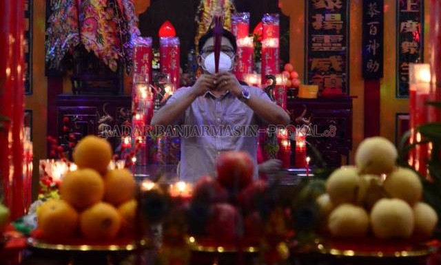 BAKAR HIO: Warga Tionghoa yang beribadah di Kelenteng Po An Kiong mengenakan masker. Jumla yang bersembahyang juga dibatasi pengelola. | FOTO: WAHYU RAMADHAN/RADAR BANJARMASIN