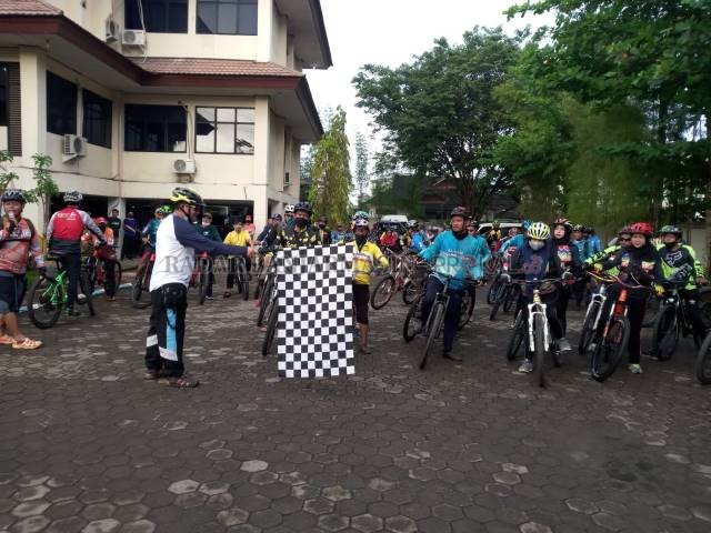 START: Kadispora Kalsel Hermansyah mengangkat bendera melepas para peserta gowes antar komunitas yang dimulai di Kantor Dispora Kalsel, Minggu (28/3) pagi.