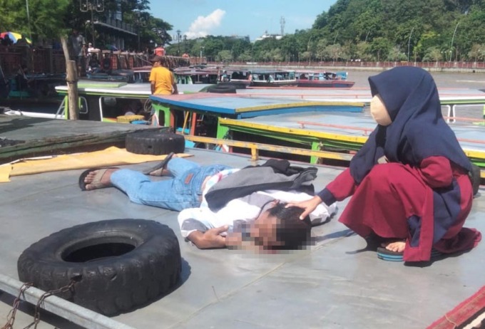 TERGELETAK:Tak sadarkan diri Mat Seleh setelah terbentur beton jembatan Pasar Lama.