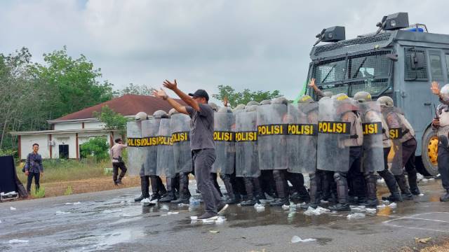 SIMULASI : Puluhan personel anti huru-hara Polres Balangan saat bersiaga menghadapi massa yang mulai beringas. : FOTO WAHYUDI RADAR BANJARMASIN.