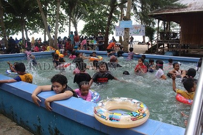 LIBURAN: Pengunjung yang rerata warga Tarakan menikmati liburan Tahun Baru di Pantai Amal, Tarakan Timur, Minggu (2/1). FOTO: AGUS DIAN ZAKARIA/RADAR TARAKAN