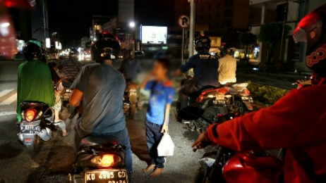 BERJUALAN: Salah seorang anak tampak berjualan di lampu merah di Simpang GTM Tarakan, Senin (10/1). FOTO: IFRANSYAH/RADAR TARAKAN