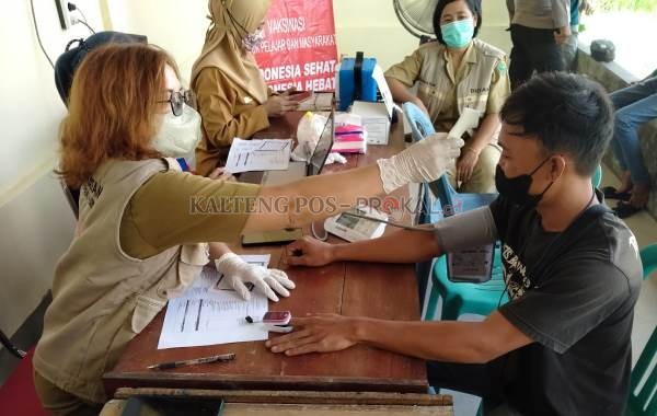 Petugas melakukan skrining terhadap warga yang akan mengikuti vaksinasi Covid-19 oleh Binda Kalteng, Jumat (10/6/2022)