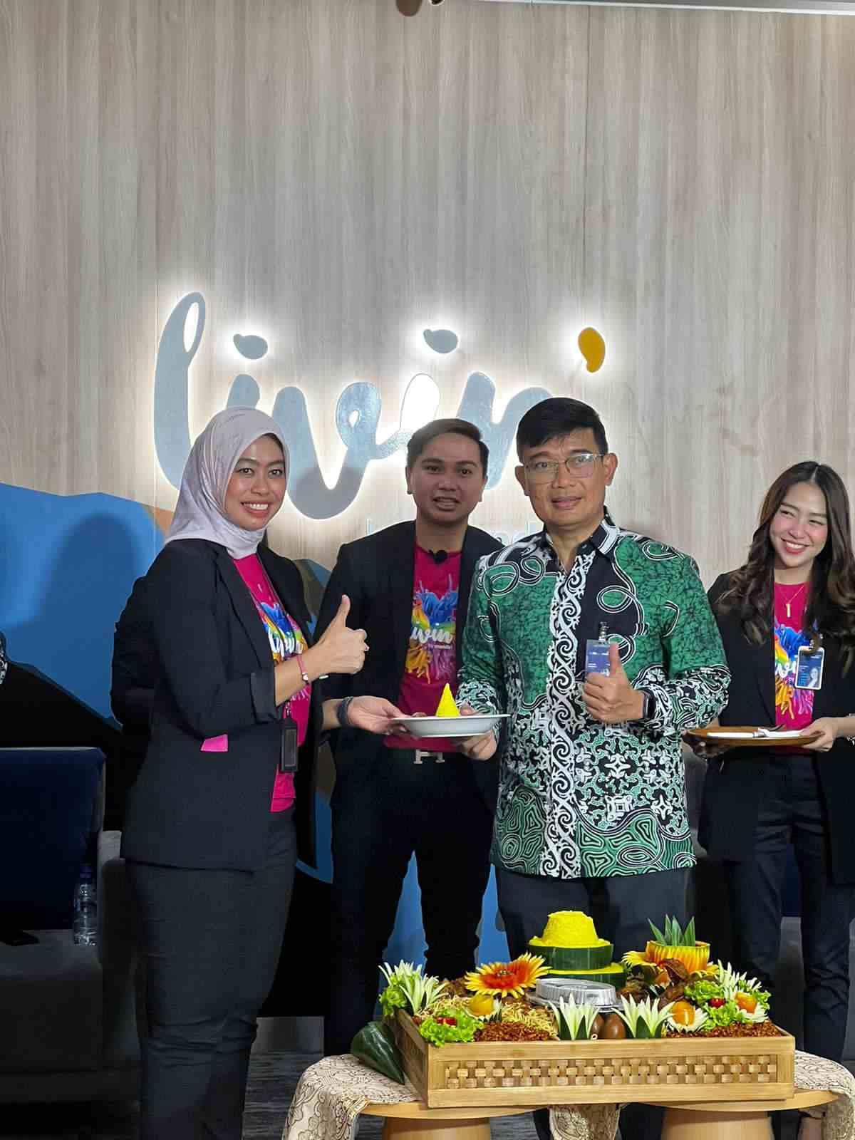 Vice President Bank Mandiri Area Balikpapan menyerahkan potongan tumpeng peresmian smartbranch kepada Isda Riana Branch Manager KC Balikpapan Klandasan.