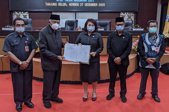 PERSETUJUAN: Wagub Kaltara H Udin Hianggio dan Ketua DPRD Kaltara Norhayati Andris, menunjukkan dokumen persetujuan bersama RAPBD Kaltara 2021, Minggu (27/12) sore.