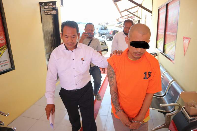 Tersangka Id (oranye) tertunduk diam saat dilakukan rilis oleh Polres Berau Senin (20/6).