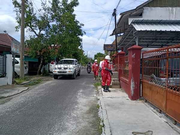 SEMANGAT: Tim gugus tugas Covid-19 Pemkot Palangka Raya sedang menyemprotkan desinfektan di permukiman warga.(HMS/RADAR PALANGKA)