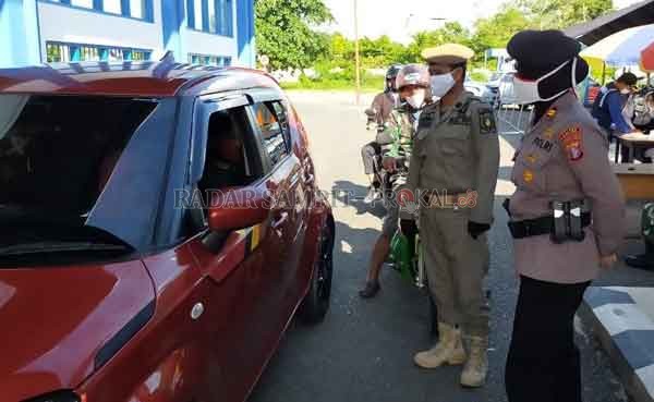 PEMERIKSAAN : Kapolsek Kapuas Timur Iptu Siti Rabiyatul bersama anggota Pol PP memeriksa kelengkapan para masyarakat yang melintas masuk ke Kabupaten kapuas.(ALEXANDER/RADAR SAMPIT)
