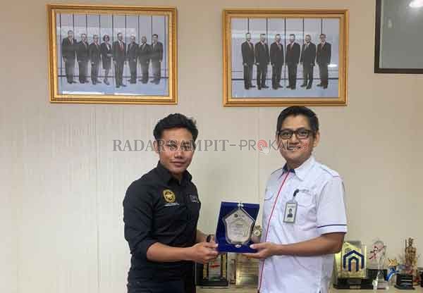 Ketua DPC Appernas Jaya Kabupaten Kotawaringin Timur Wengga Febri Dwitananda menyerahkan penghargaan kepada Pemimpin BTN Cabang Palangka Raya Fikry Ghazali, Rabu (8/7).