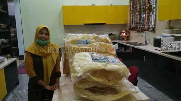 RAKSASA : Roihatul Jannah menunjukkan kerupuk sorgum dewa yang merupakan produk khas desa Pangkalan Dewa, Kecamatan Pangkalan Lada.(SYAMSUDIN/RADAR PANGKALAN BUN)