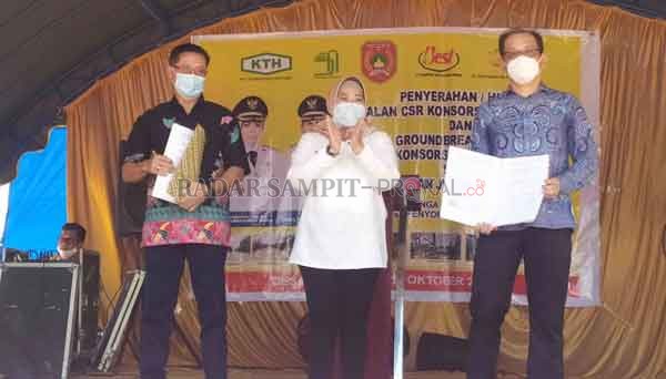 Konsorsium : Direktur PT Korintiga Hutani Park Jong Myung (kanan) saat penyerahan pembangunan jalan saksikan Bupati Kobar Hj Nurhidayah di Desa Nanga Mua Kamis (22/10). (RINDUWAN/ RADAR PANGKALAN BUN )