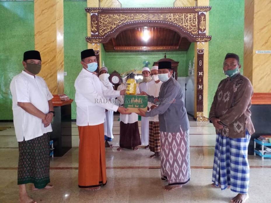 SERAHKAN BANTUAN : Ketua DMI Sukamara Windu Subagio saat menyerahkan bantuan peralatan kebersihan kepada pengurus masjid. (FAUZIANUR/RADAR SAMPIT)