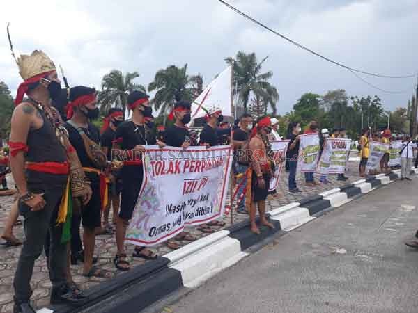 AKSI DAMAI: Puluhan ormas Dayak dari berbagai elemen menggelar aksi damai di Bundaran Besar Palangka Raya, Rabu (16/12).(DODI/RADAR PALANGKA)