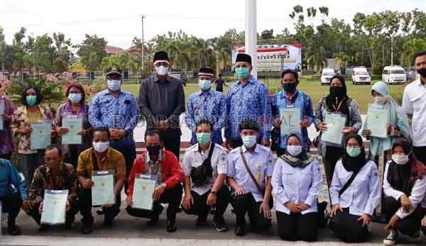 PELAYANAN : Wali Kota Palangka Raya Fairid Naparin bersama Ketua DPRD Kota Sigit K Yulianto saat bersama sejumlah warga , ketika menyampaikan sertifikat, belum lama ini.(ISTIMEWA/ HUMAS PEMKOT)