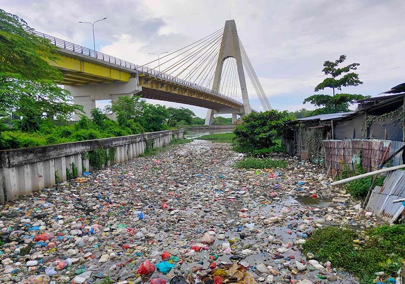 Sampah terlihat mengapung dan berserakan di aliran Sungai Siak, di bawah Jembatan Siak IV, Pekanbaru. Sampah-sampah ini menyebabkan aliran sungai tersendat.
