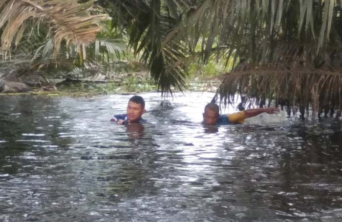 Personel Satpolair Polres Pelalawan saat melakukan pencarian korban banjir di aliran Sungai Kualo, Kabupaten Pelalawan, Selasa (23/1/2024).