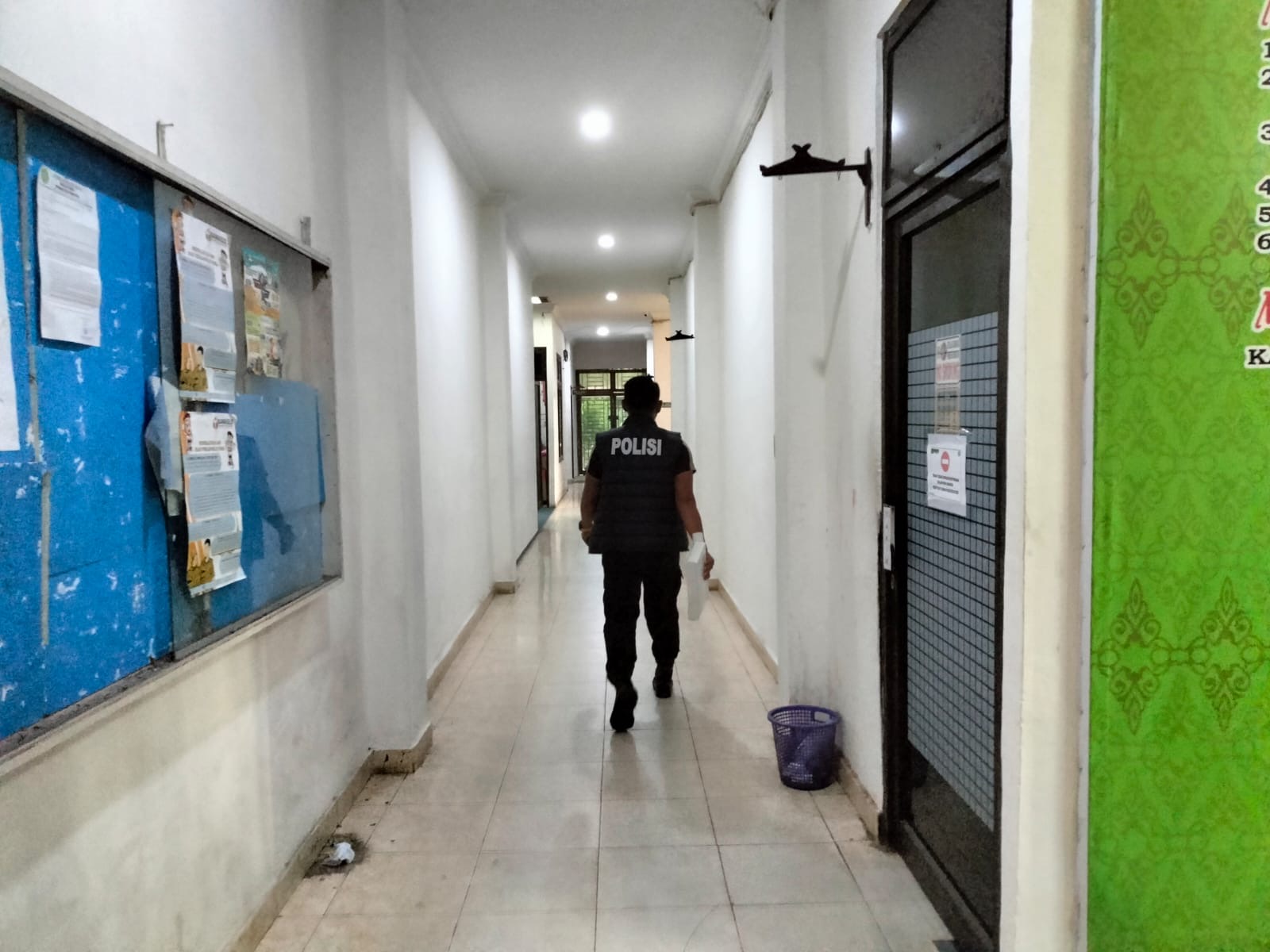 Salah seorang penyidik Satreskrim Polres Rohul sedang berjalan menujusalah satu ruangan di Kantor Disperkim Rohul, Rabu (24/1/2024).