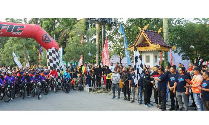 Pj Wali Kota Pekanbaru Muflihun mengangkat bendera saat pelepasan peserta Riau Pos Fun Bike di area Car Free Day depan Gedung Mal Pelayanan Publik (MPP) Pekanbaru, Ahad (28/1/2024).