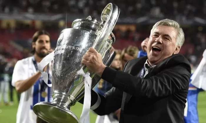 KEHILANGAN: Carlo Ancelotti saat mengangkat trofi Liga Champions. Dia tak khawatir dengan absennya Jude Bellingham jelang pertemuan dengan RB Leipzig